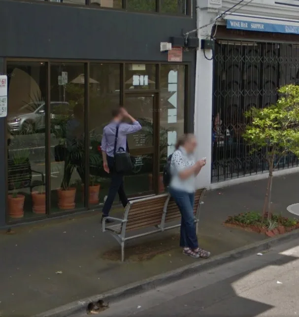 211 Swan Street exterior — Hues Hair dark glass shopfront with interior plants and street bench