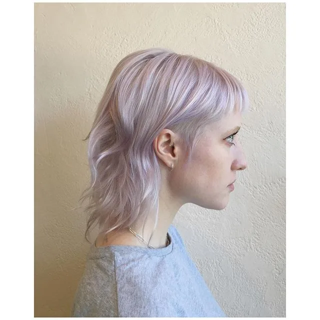 Pastel lilac-blonde tousled shag with micro-fringe